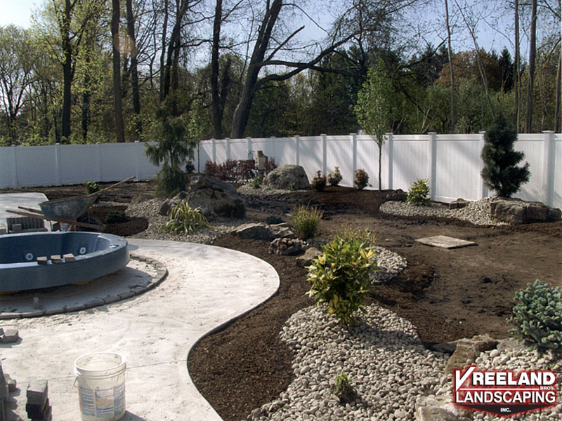 Oak Ridge, NJ, Bullnose coping, swirl finish concrete, custom plantings, paver blocks around hot tub 