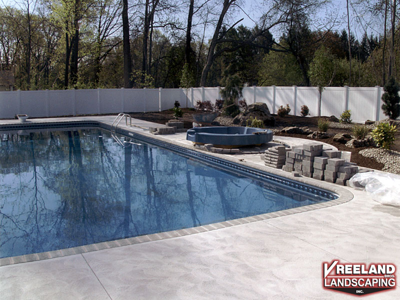 Oak Ridge, NJ, Bullnose coping, swirl finish concrete, custom plantings, paver blocks around hot tub 