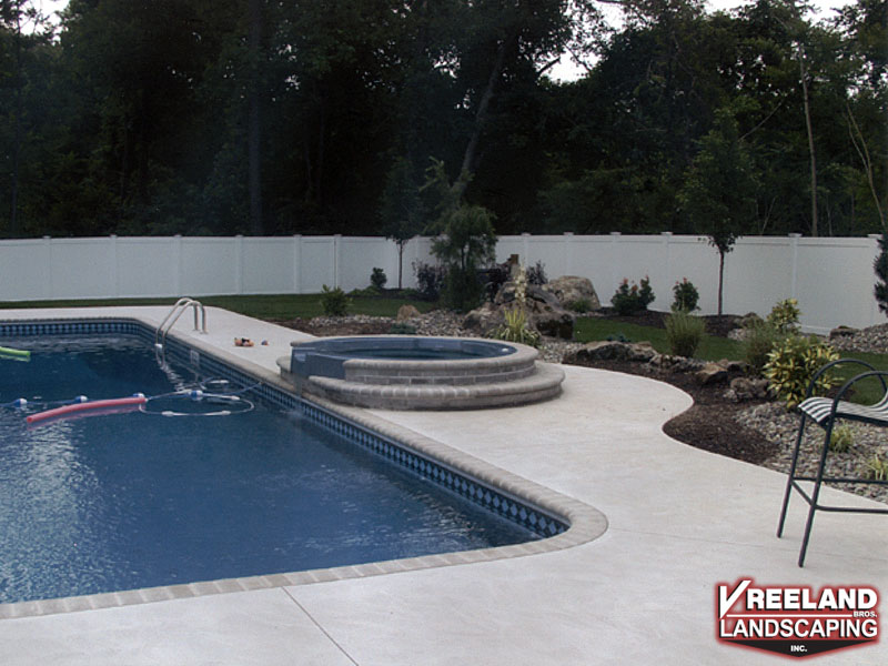 Oak Ridge, NJ, Bullnose coping, swirl finish concrete, custom plantings, paver blocks around hot tub 