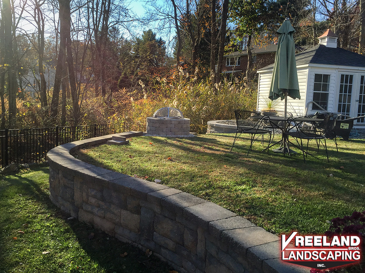 Rockaway, NJ, Decorative block retaining wall and custom built fire pit with grill 