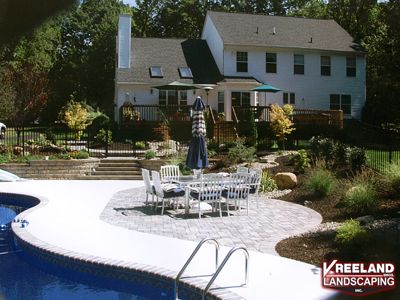 Rockaway, NJ, Existing pool was backfilled; bull nose coping, swirl finish concrete, and a paver patio installed by Vreeland Brothers. 