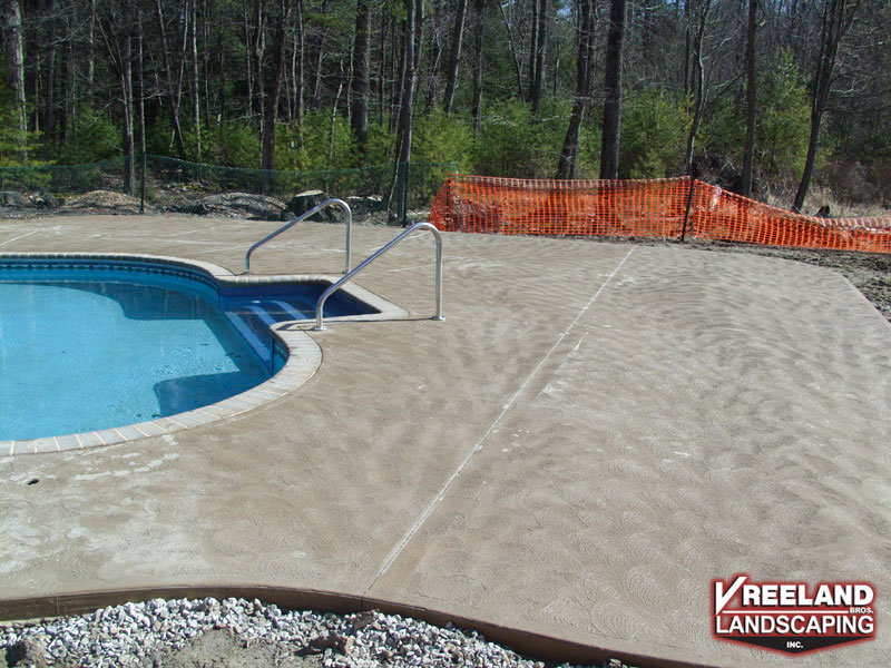 West Milford, NJ, Swirl finish concrete pool patio & bull nose coping installed around new pool 