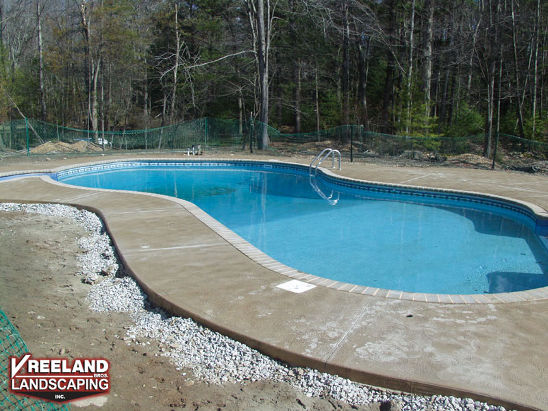 West Milford, NJ, Swirl finish concrete pool patio & bull nose coping installed around new pool 