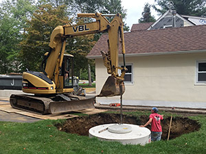 Oak Ridge, NJ - Seepage pit installation for use as a drywell in a full site drainage application - Vreeland Brothers Landscaping