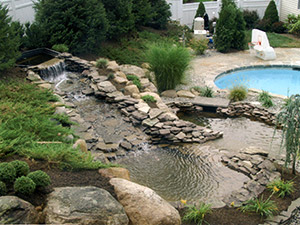 Oak Ridge, NJ - Waterfalls, pond, and landscaping added to existing pool - Vreeland Brothers Landscaping