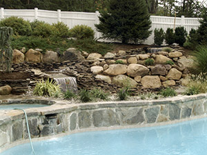 Oak Ridge, NJ - Waterfalls, pond, and landscaping added to existing pool - Vreeland Brothers Landscaping